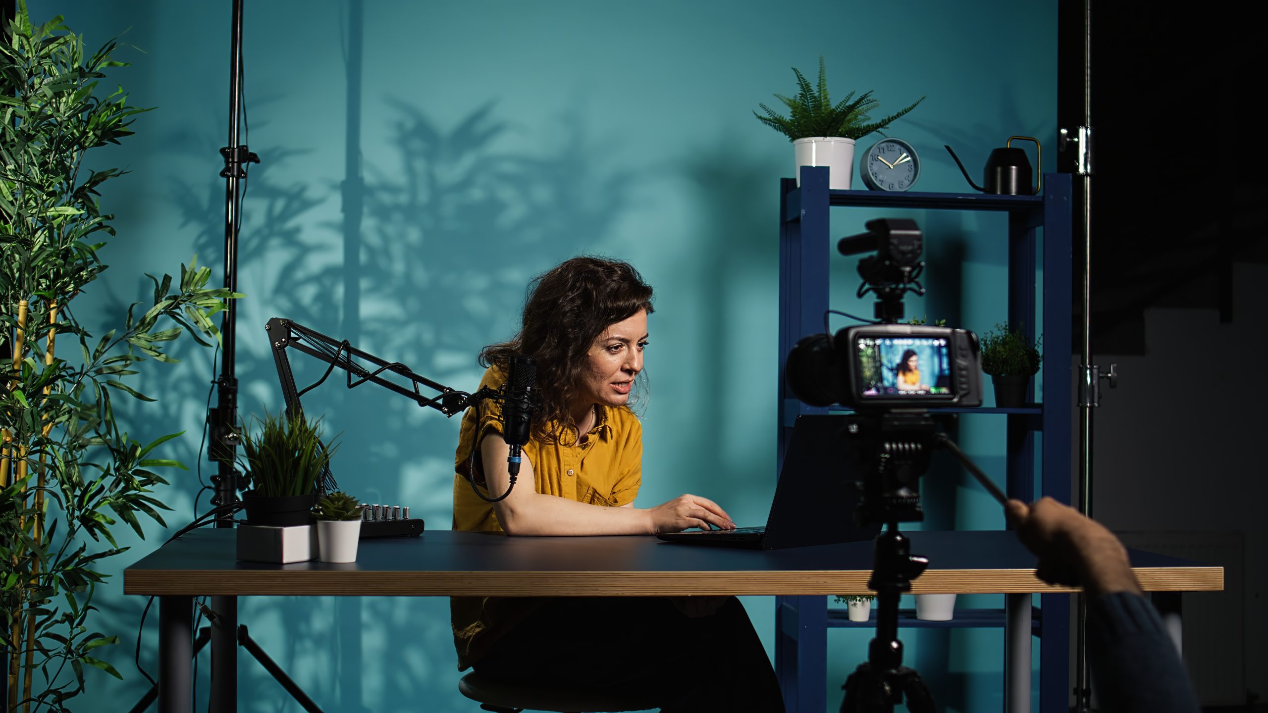 Content creator using production camera gear to film motivational type video for fans. Online show host using professional microphone to share inspiring quotes to viewers, camera B